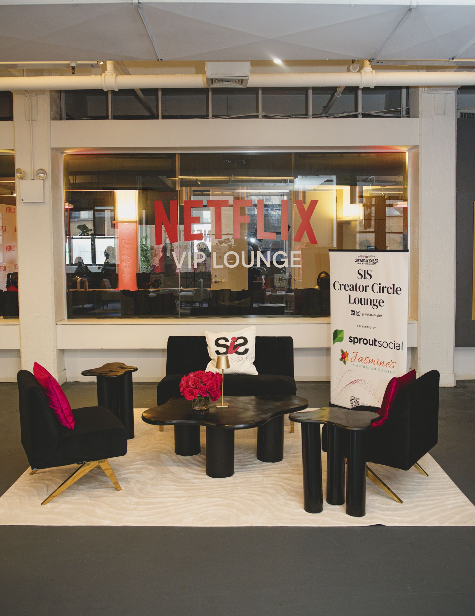 Lounge seating with Sistas in Sales and Netflix branded pillows