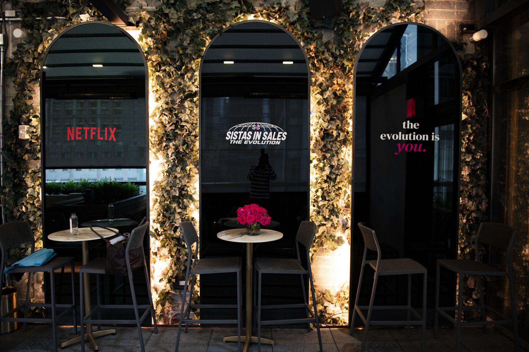 Ivy-covered arches lit with Netflix, Sistas in Sales and “the evolution is you.” signage