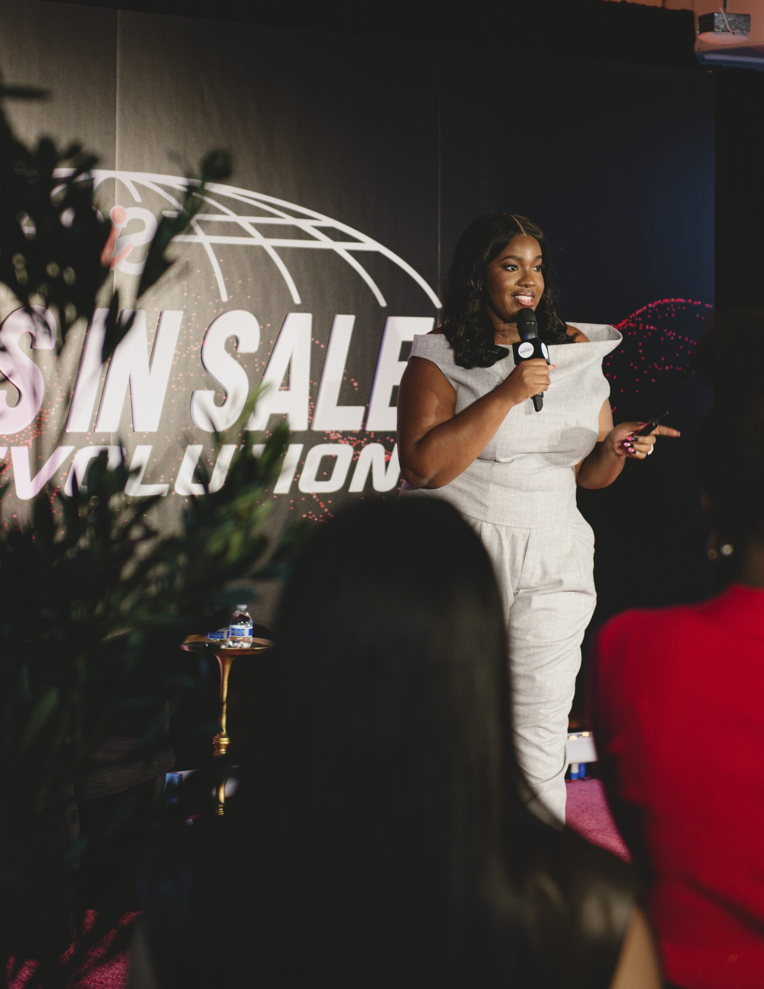Speaker addressing the audience with a microphone on the Evolution stage