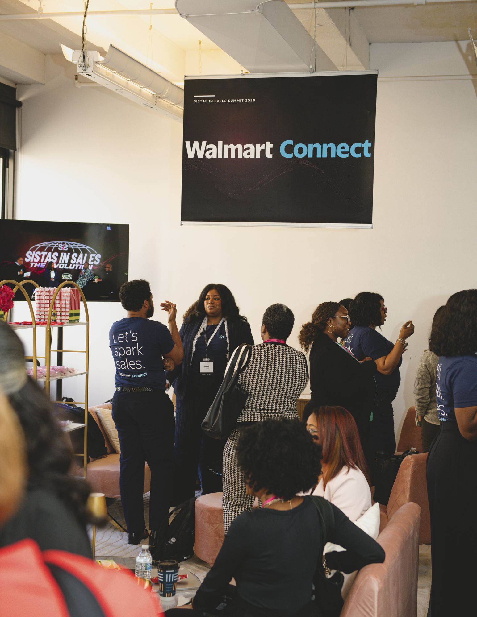 Attendees gathered beneath the Walmart Connect sign