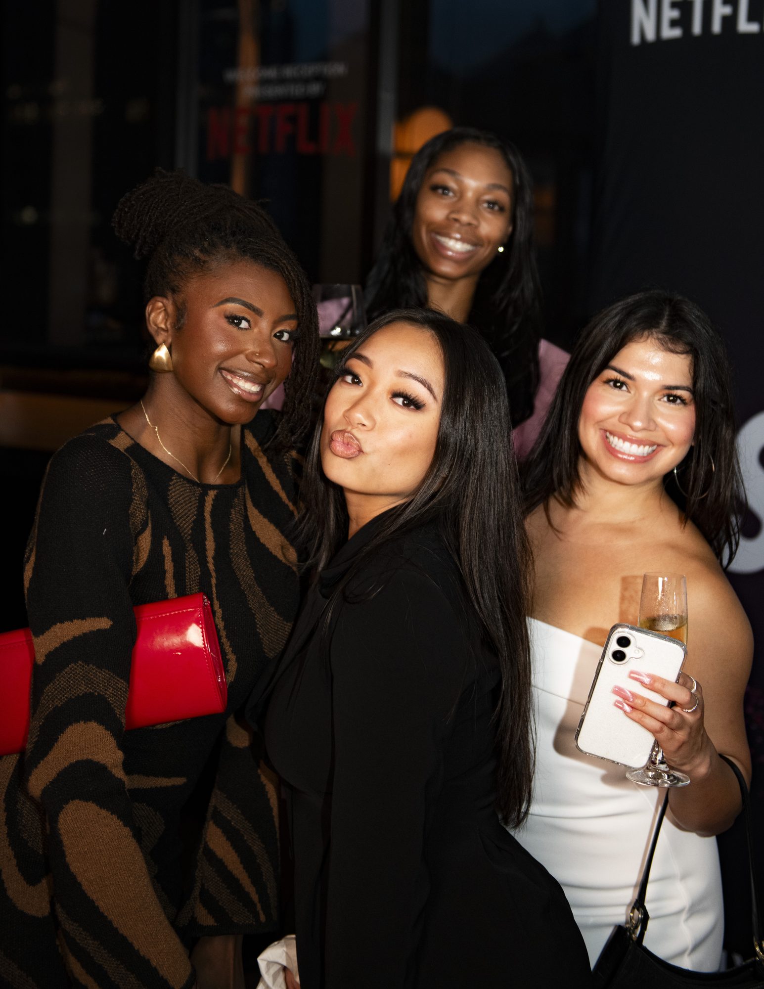 Four guests posing together for a close-up photo