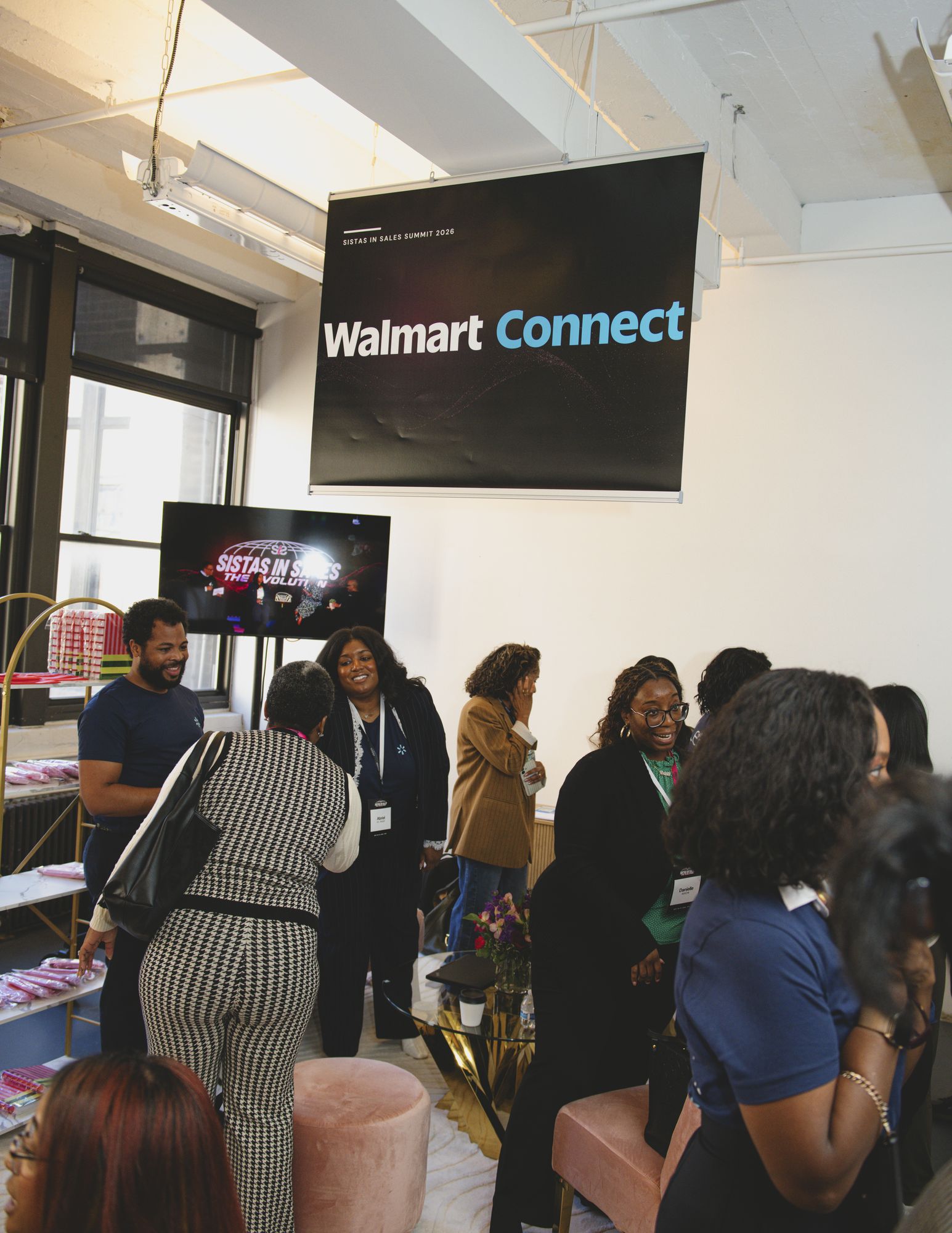 Attendees networking under the Walmart Connect banner