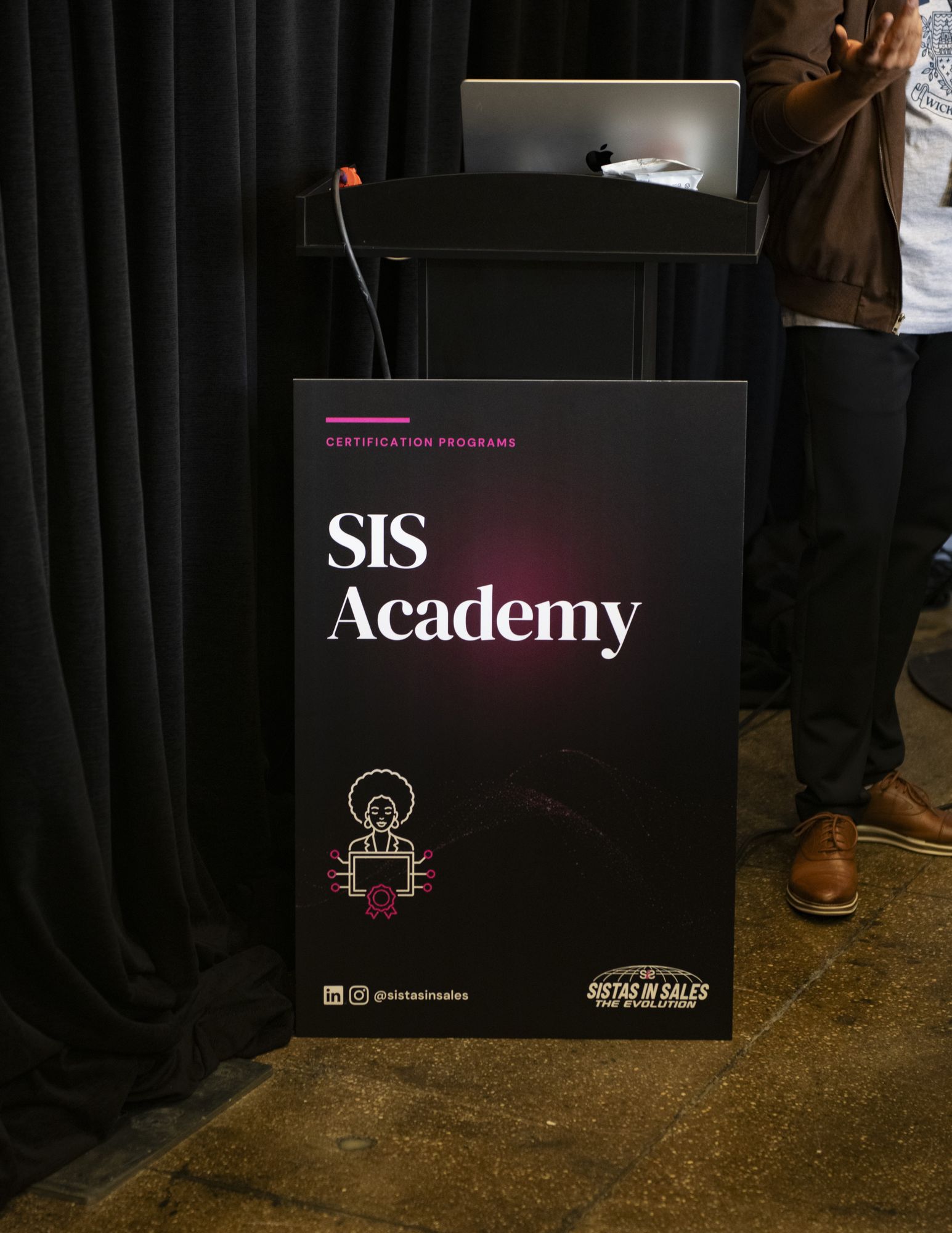 SIS Academy podium sign in the training room