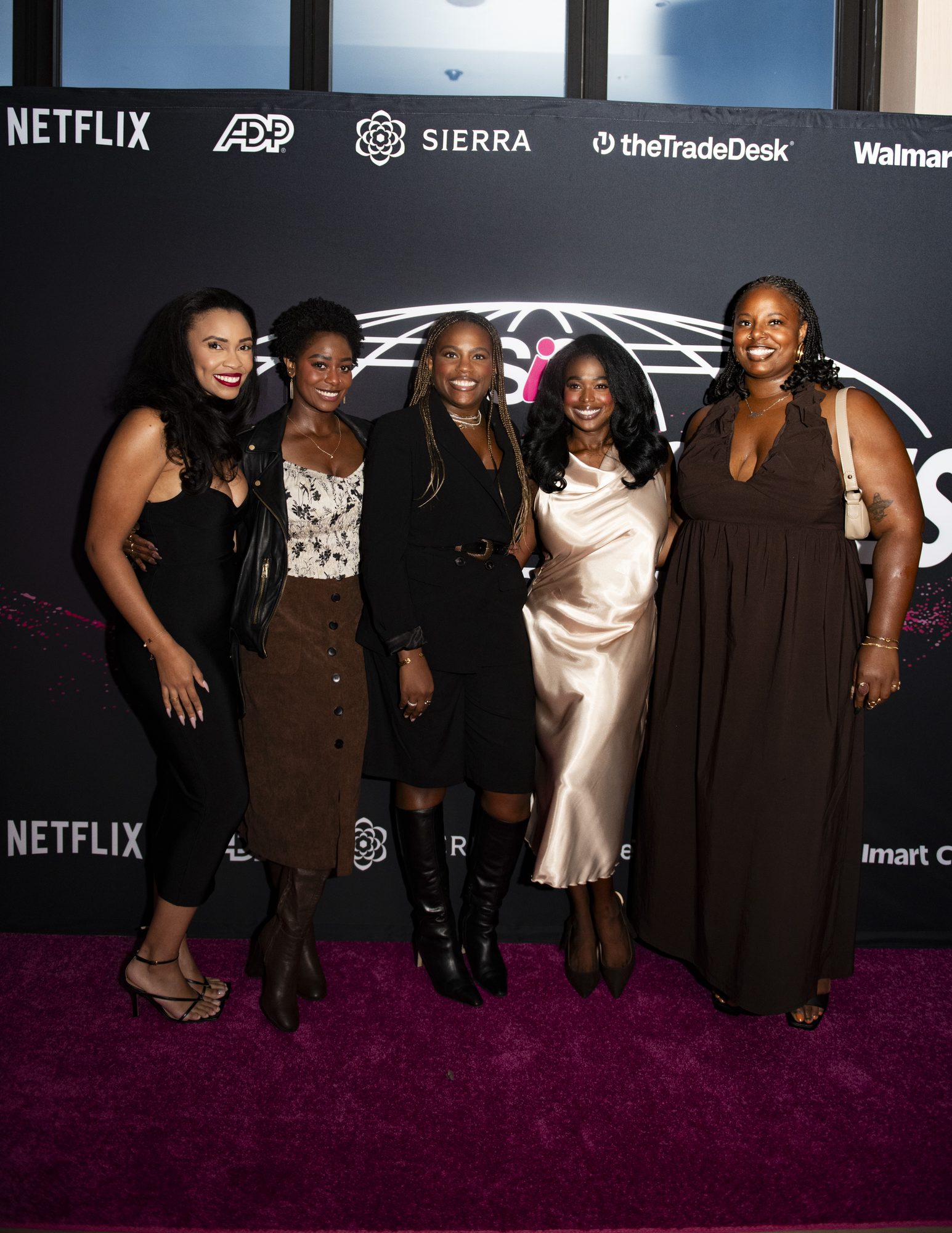 Guests posing at the step-and-repeat with Netflix, ADP, Sierra, The Trade Desk and Walmart Connect logos