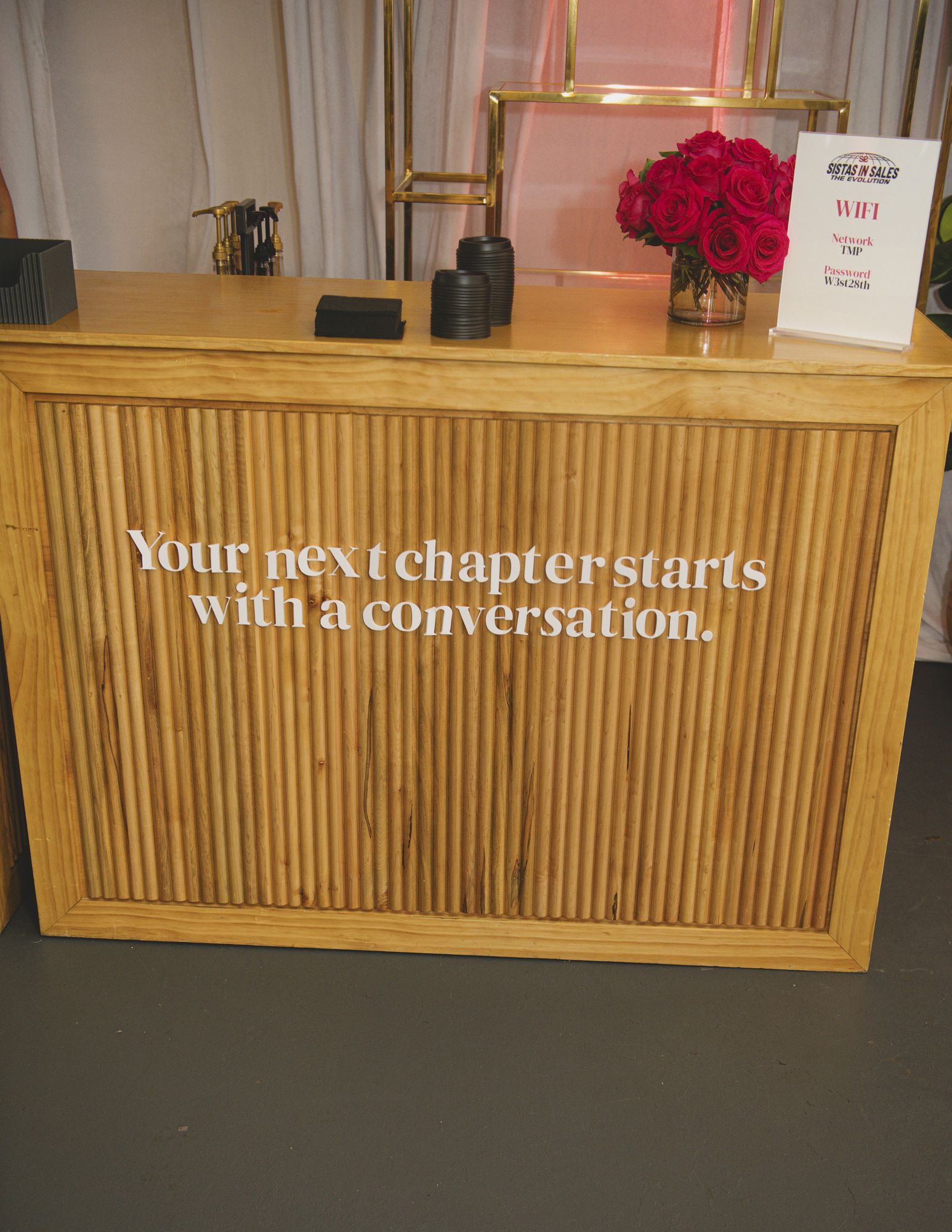 Welcome desk reading “Your next chapter starts with a conversation.”