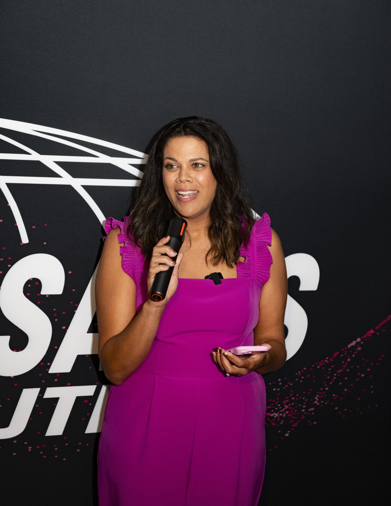 Guest giving welcome remarks with a microphone