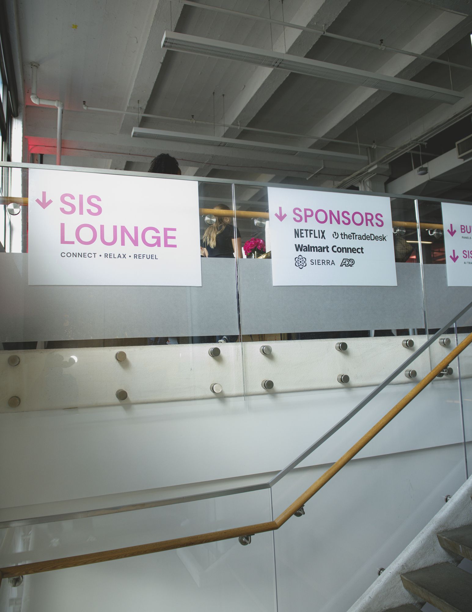 Wayfinding sign pointing to the SIS Lounge and sponsor spaces